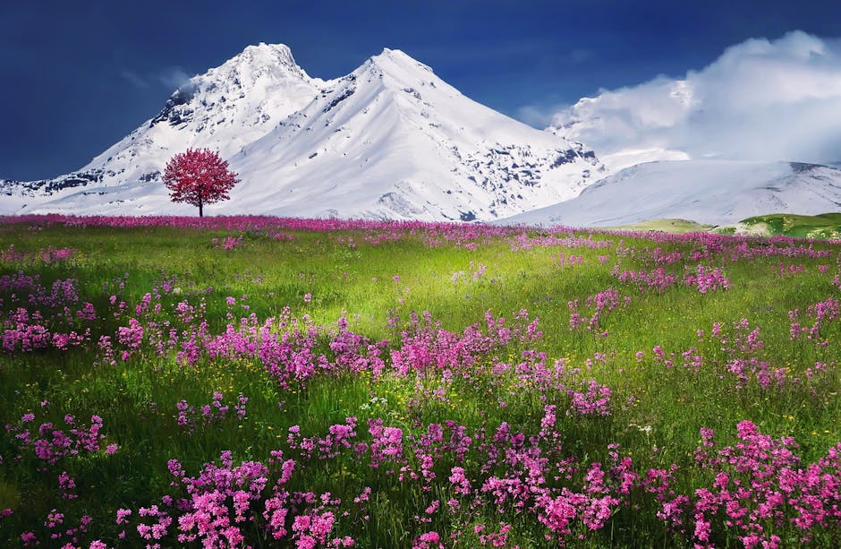 Paesaggio suggestivo con montagne innevate, prato fiorito e albero solitario rosso, evocativo di atmosfere cinematografiche burgessiane e kubrickiane.
