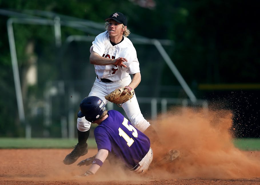 Baseball: Impegno e Spirito di Squadra per la Difesa Azione dinamica di baseball: giocatore scivola in base mentre un altro tenta la presa, simbolo di impegno e difesa nazionale.