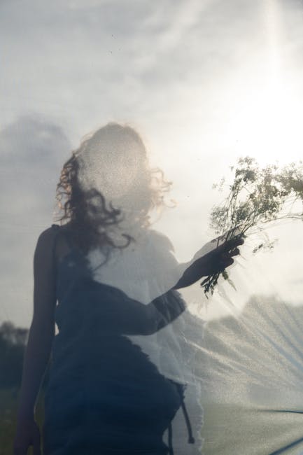Donna con fiori e velo trasparente: un'immagine che evoca armonia e bellezza, in linea con il Reticolo Aureo. Scopri il segreto.