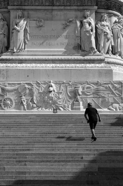 Persona sale scalinata del Vittoriano a Roma, simbolo di rinnovamento e impegno per l'istruzione come il sito La Tecnica della Scuola.