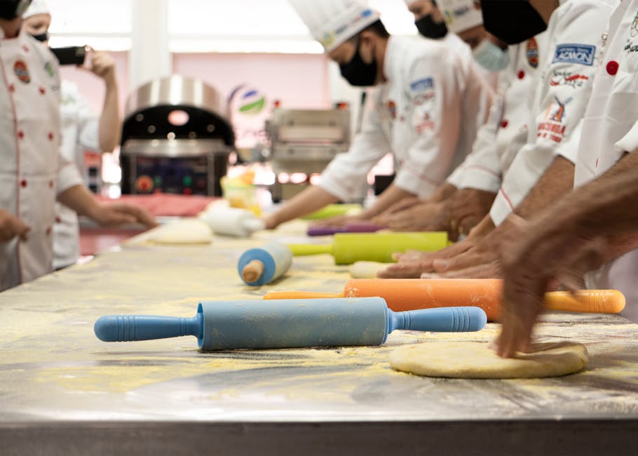 Studenti alberghieri al lavoro con matterelli colorati durante il Campionato nazionale di pasticceria a Riposto 2026. Preparazione dolci.