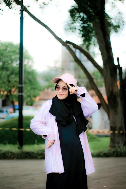 Insegnante con hijab e cappellino rosa esprime incertezza sugli arretrati CCNL scuola 2022-2024, chiedendo chiarimenti al MEF.