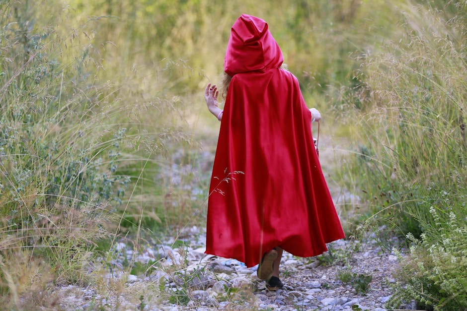 Bambina vestita da Cappuccetto Rosso nel bosco: fiaba, avventura e magia per bambini. Illustrazione per racconti e insegnamenti preziosi.