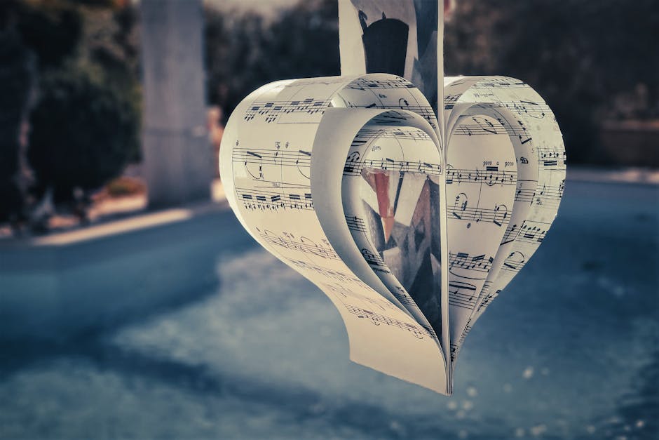 Cuore di spartiti musicali sospeso, simbolo di amore per la musica e creatività, viaggio emozionale nel suono, divertimento musicale unico.
