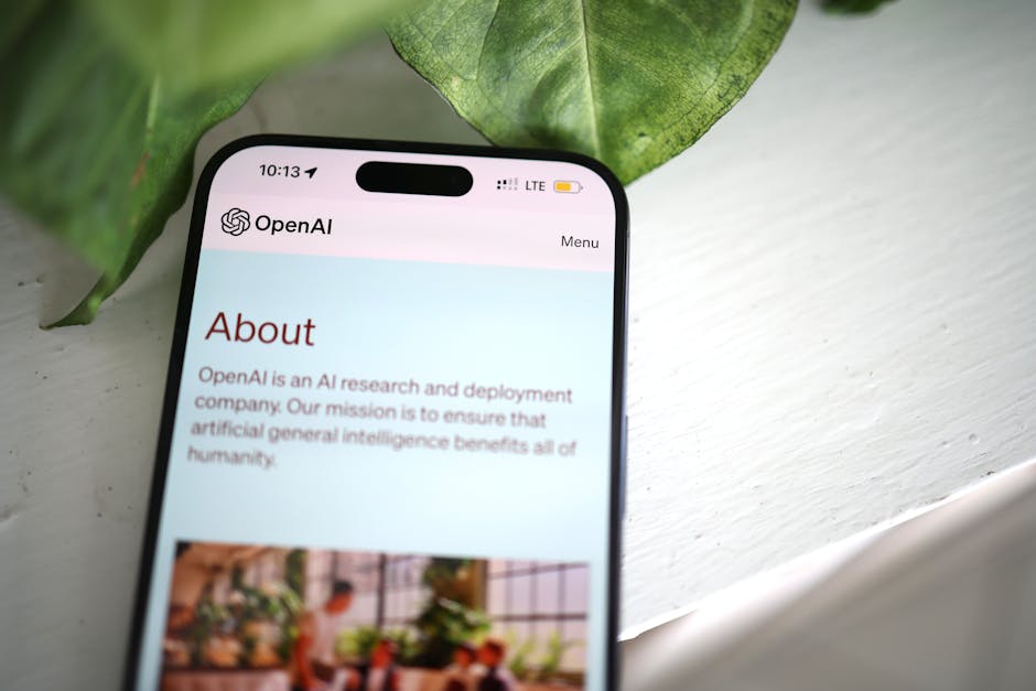 Schermata smartphone con pagina About di OpenAI, focus sull'intelligenza artificiale e l'allarme di Matt Shumer sull'AI