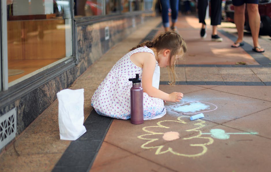 Bambina che disegna con i gessetti sul marciapiede, apprendimento creativo e personalizzato, tecniche di espressione artistica per bambini