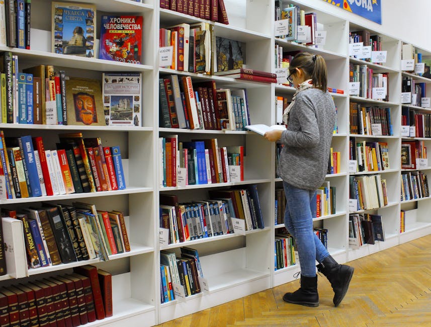 Studentessa consulta libri in biblioteca: metafora delle scelte scolastiche e disparità tra studenti italiani e stranieri