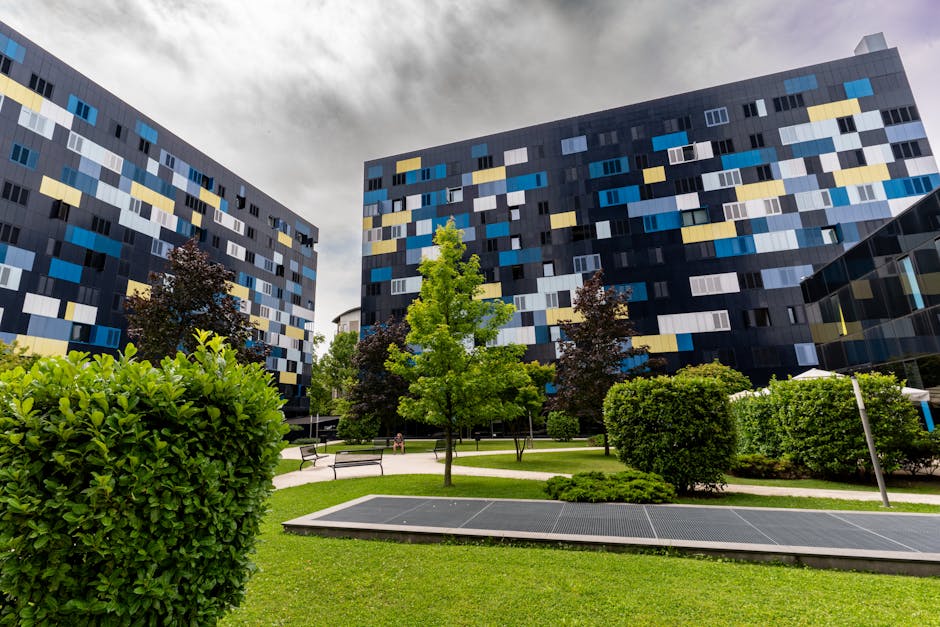 Studentato ex Villaggio Olimpico Milano: vista esterna degli edifici con facciate colorate e aree verdi, residenze universitarie e alloggi