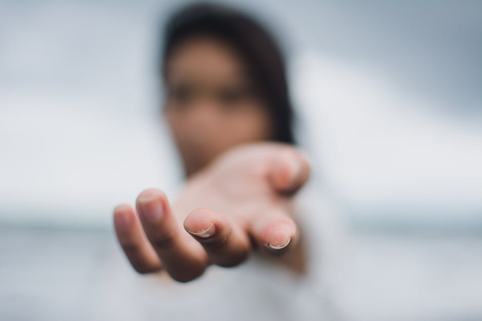 Mano tesa in primo piano simbolo di aiuto e supporto per affrontare le malattie e le loro diverse dimensioni