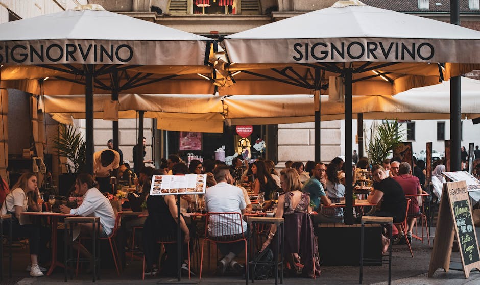 Ristorante Signorvino affollato con persone sedute ai tavoli all'aperto, implicazioni per i buoni pasto e la ristorazione scolastica