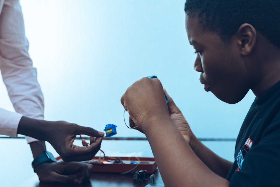 Studente e docente collaborano a progetto di robotica educativa, promuovendo l'istruzione innovativa e la collaborazione tra docenti