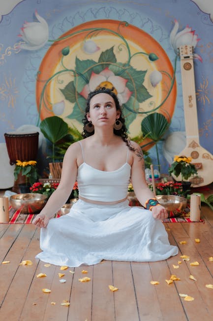Donna in meditazione con strumenti musicali e fiori, benefici della musica per la salute e il benessere, rilassamento e armonia.