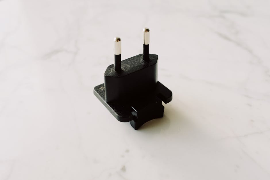 Calcolo densità: adattatore presa elettrica nero, utile per misurazioni precise con convertitore grammi litro.