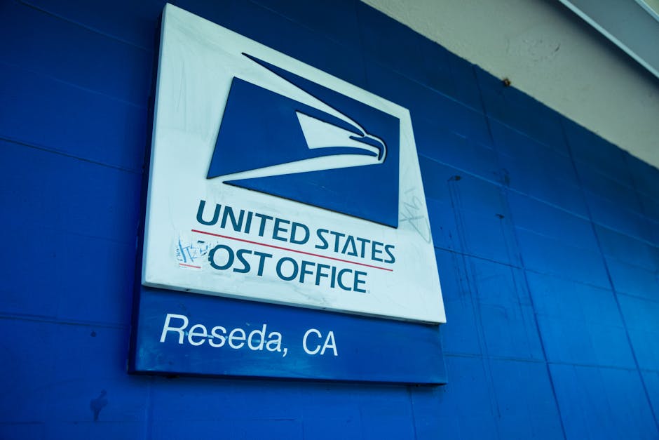 Insegna dell'ufficio postale degli Stati Uniti a Reseda, California, con il logo dell'aquila stilizzata e la scritta United States Post Office.