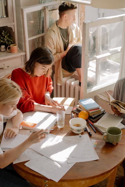 Studenti che studiano insieme per l'esame di maturità, strategie di preparazione, libri e appunti sul tavolo di legno.