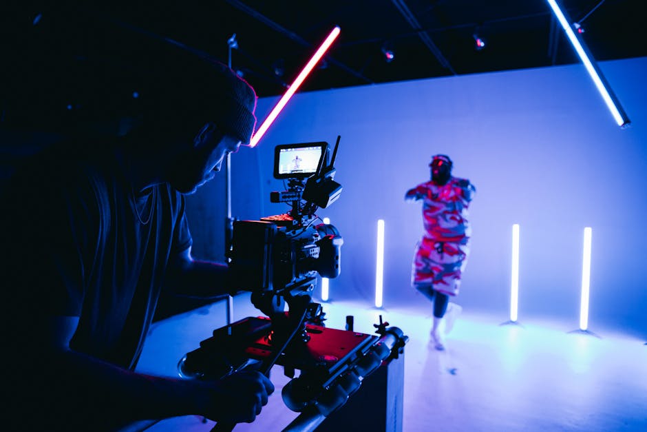 Dietro le quinte di un giovane cineasta al Festival del Cinema Scolastico, riprese con luci al neon e performer in scena.