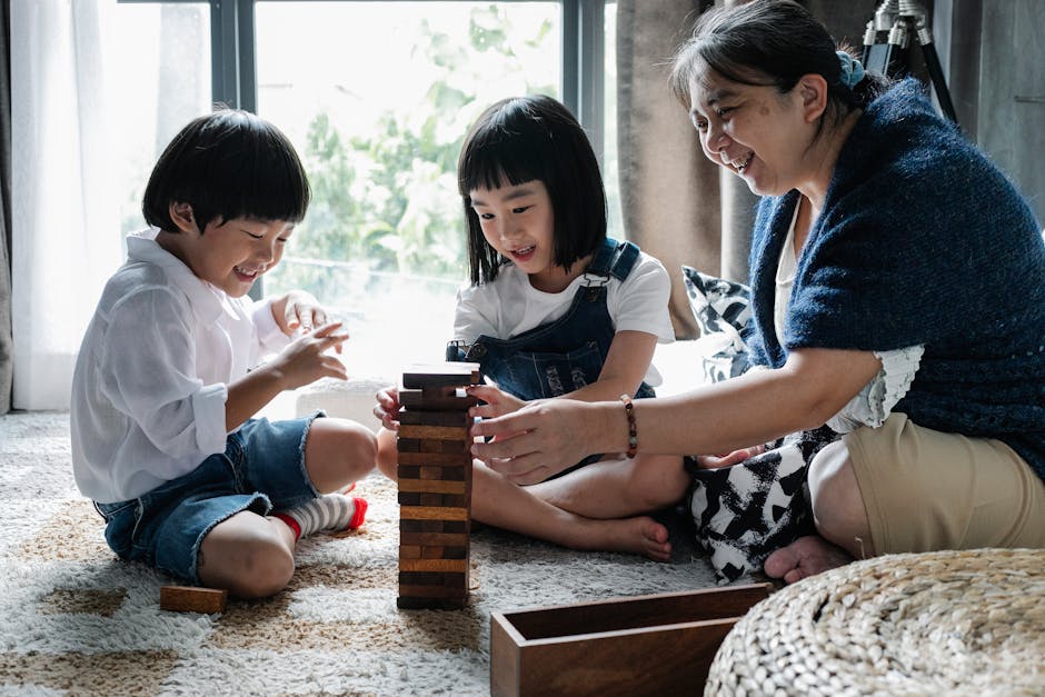 Nonni e nipoti giocano insieme a Jenga, promuovendo relazioni familiari sane e cooperative attraverso il gioco intergenerazionale.