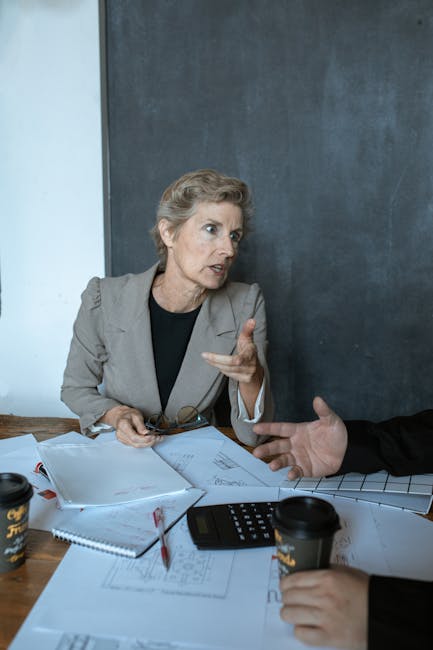 Donna spiega calcoli complessi con calcolatrice e schemi, ottimizzando le decisioni grazie al calcolatore di potenze.