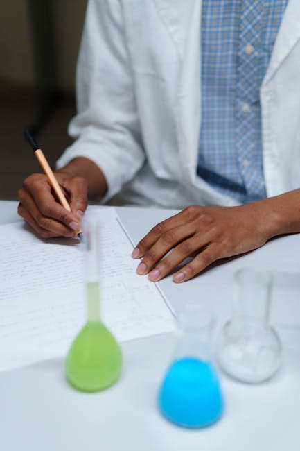 Ricerca scientifica in laboratorio: scienziato prende appunti con provette colorate, analisi e sicurezza in ambito scolastico dopo l'incidente
