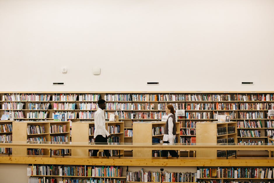 Studenti di diverse etnie in biblioteca: un esempio di educazione multiculturale e inclusione tra i libri e la conoscenza.