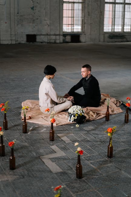 Interazione faccia a faccia: coppia seduta con fiori, simboleggia la connessione umana e la costruzione di legami profondi e significativi.