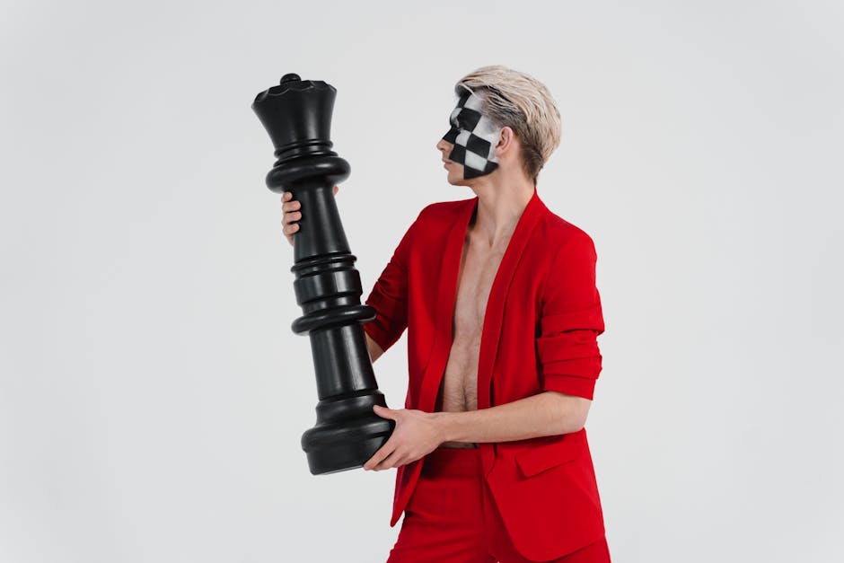 Uomo con scacchiera dipinta sul viso tiene una regina degli scacchi gigante per pianificazione strategica efficace