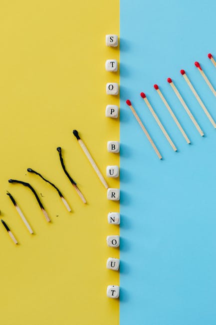 Fiammiferi accesi e spenti con dadi che compongono la parola burnout: metafora del benessere dei docenti e prevenzione del burnout