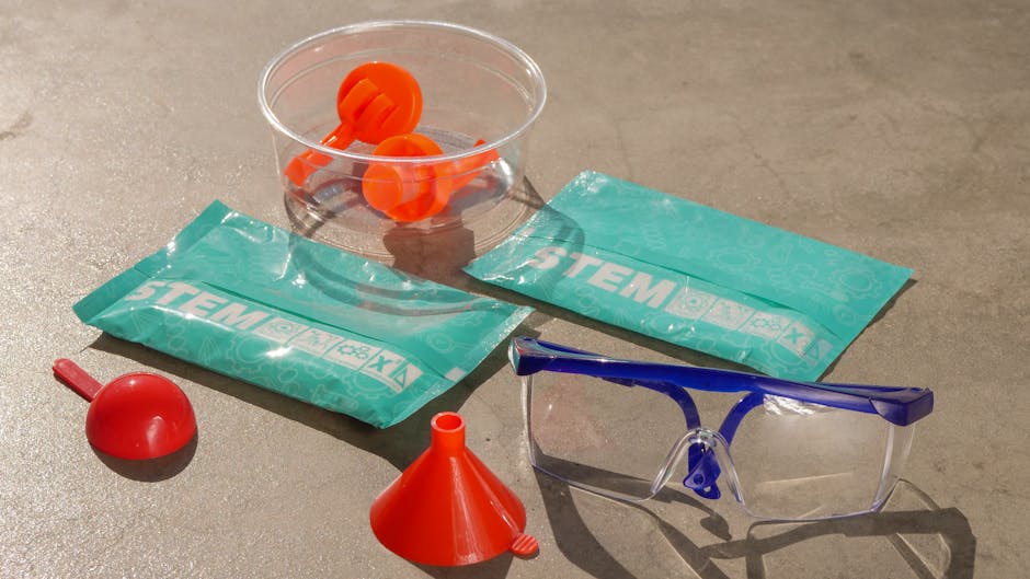 Kit didattico STEM per esperimenti scientifici con misurini, imbuto, occhiali protettivi e bustine di reagenti per l'apprendimento attivo.