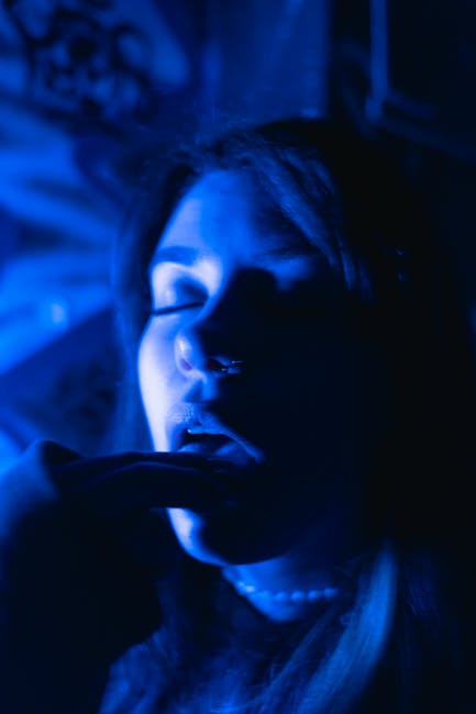 Ritratto enigmatico di donna con illuminazione blu intensa, espressione pensierosa, evocativa delle sfide e dei misteri della Terza Crociata.