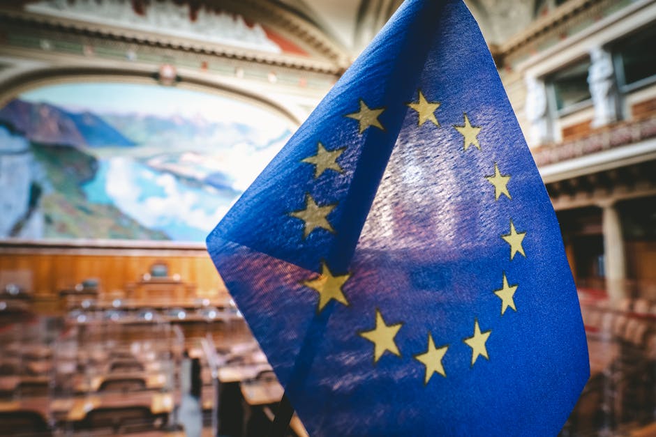 Bandiera UE in parlamento europeo, simbolo della crescente presenza femminile nelle istituzioni europee e italiane