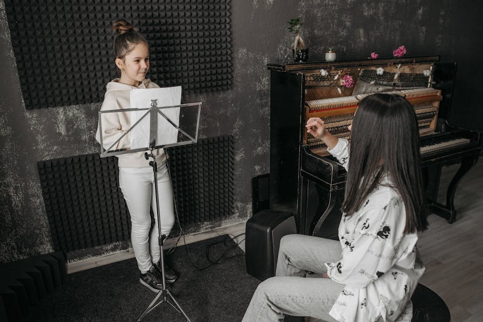 Ragazza studia canto con insegnante al pianoforte, sviluppando il talento musicale unico e le proprie abilità canore in studio di registrazione.