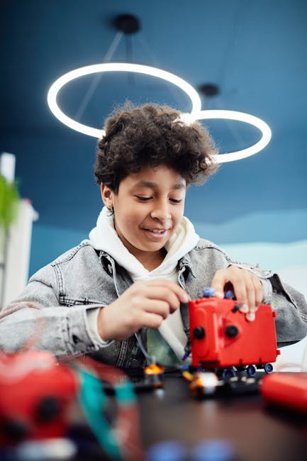 Ragazzo che costruisce un robot rosso: apprendimento personalizzato con IA per il futuro dell'istruzione e sviluppo di competenze STEM