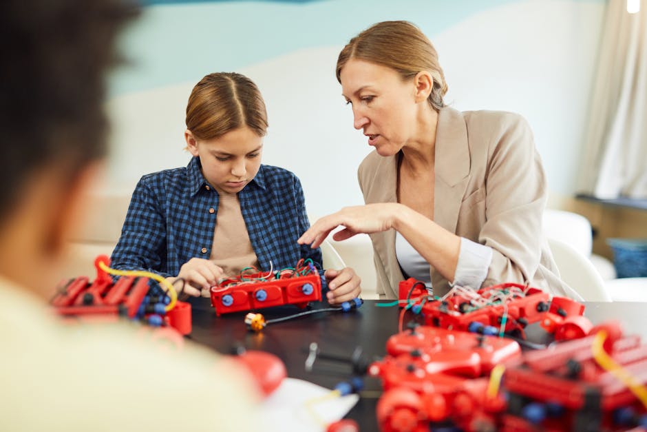 Lorena Ronchi, insegnante innovativa, guida un allievo nell'assemblaggio di un robot, dimostrando passione e competenza nell'insegnamento STEM.