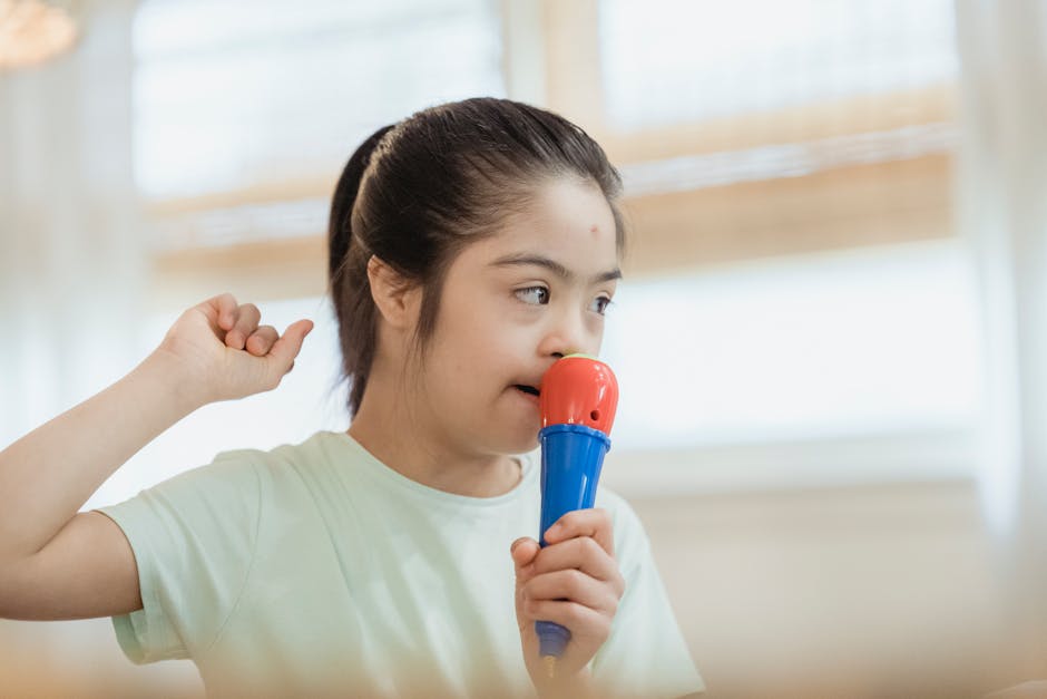 Bambina con sindrome di Down canta con microfono giocattolo, attività musicale per bambini, stimolazione creativa e divertimento