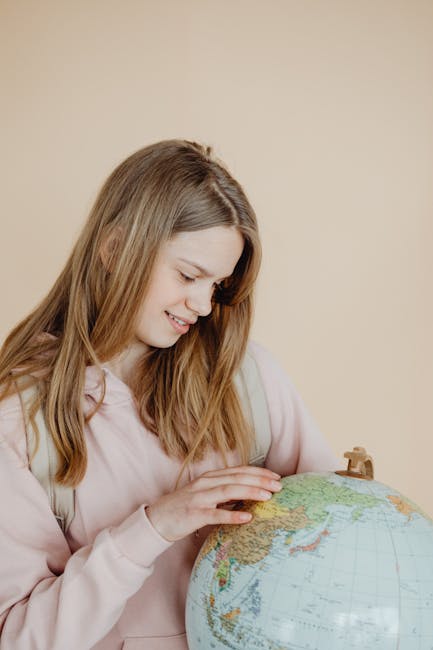 Studentessa osserva un globo terrestre: intelligenza artificiale per la valutazione scolastica e apprendimento personalizzato