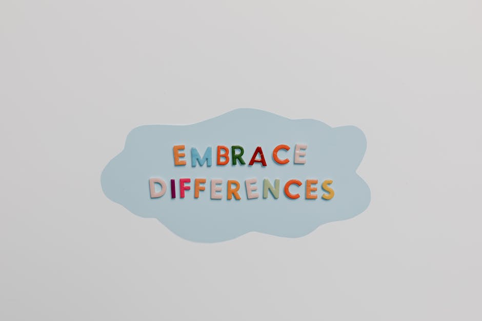 Lettere colorate che formano la frase Embrace Differences su sfondo azzurro, simbolo di inclusione e accettazione delle diversità nei viaggi di istruzione.
