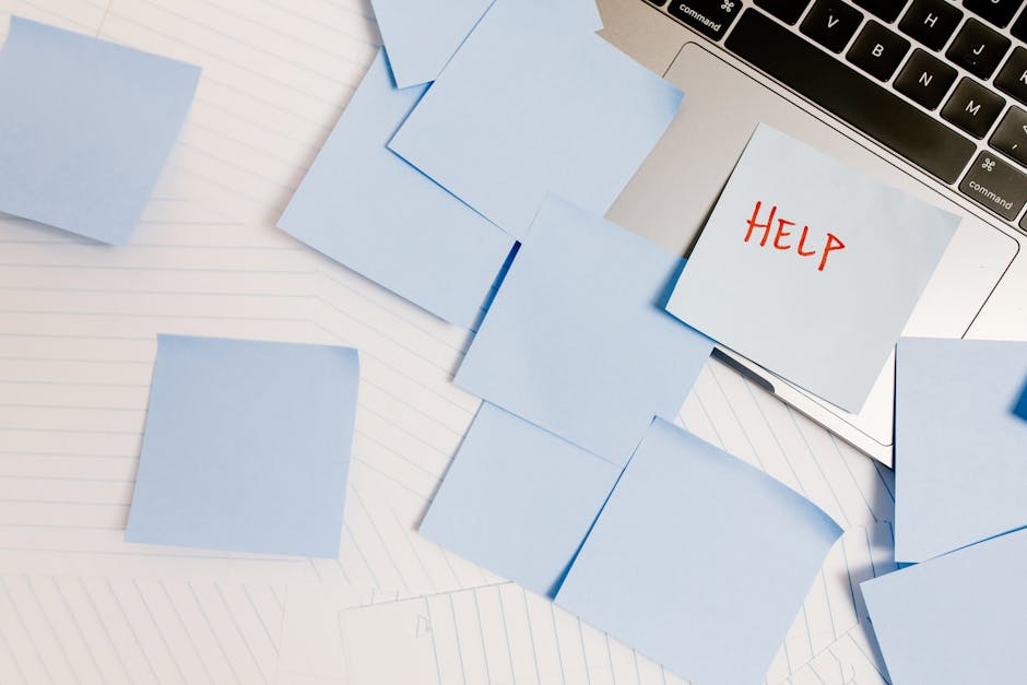 Post-it con la scritta AIUTO su un laptop, circondato da altri promemoria: tecniche di gestione del tempo per insegnanti impegnati.