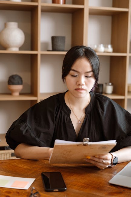 Pianificazione efficace: unità didattiche e apprendimento Docente che pianifica unità didattiche e di apprendimento con appunti e smartphone sulla scrivania in ufficio