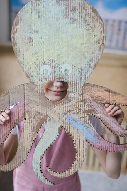 Bambina con maschera da polpo in cartone, attività ritmiche e creative per bambini, gioco e apprendimento attraverso il movimento