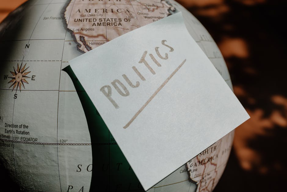 Globo geografico con appunto 'Politics', simbolo di comunicazione interculturale e geopolitica nel mondo globalizzato.