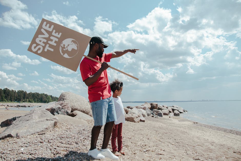 Uomo e bambina con cartello Save the Planet: riflessioni sul futuro, come la Carta del docente