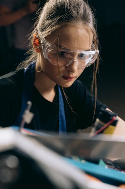 Giovane donna con occhiali protettivi lavora su progetto tecnico, preparazione alle competenze del futuro professionale