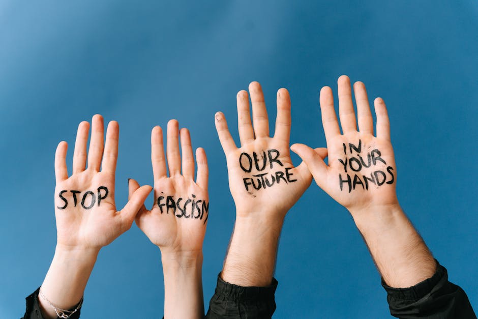 Mani con scritte Stop Fascismo Our Future In Your Hands su sfondo blu per articolo ripetizioni inglese e futuro