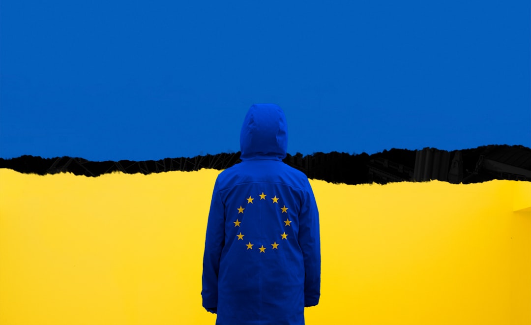 Persona con giacca UE di fronte a sfondo giallo e blu, simbolo di competenze e solidarietà europea per il futuro.