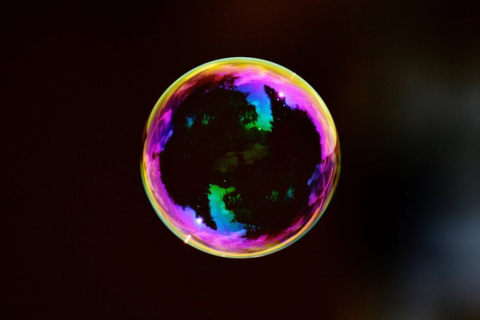 Bolla di sapone con riflessi iridescenti che illustra i principi fisici dell'ottica e della rifrazione della luce nella fisica generale.